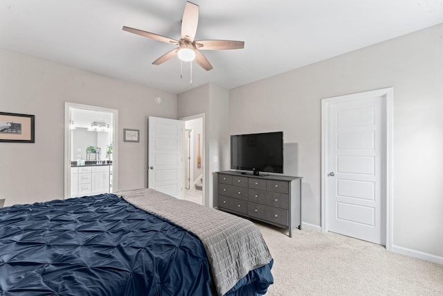 bedroom with light carpet, baseboards, ensuite bath, and ceiling fan