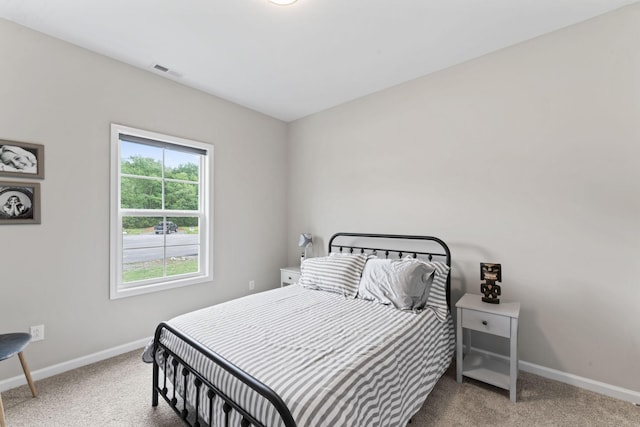 carpeted bedroom featuring baseboards