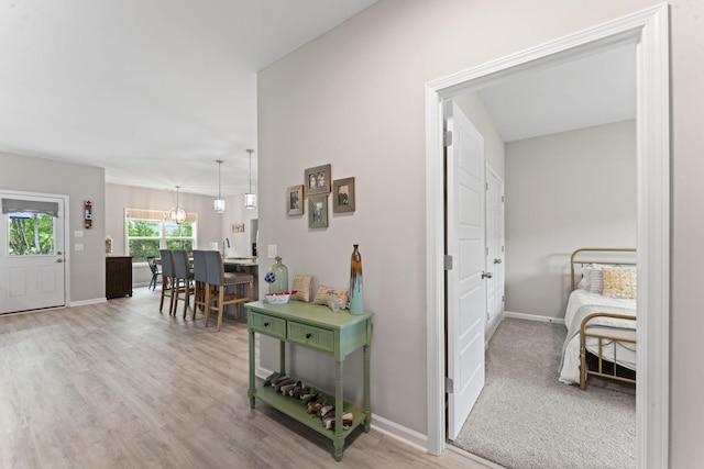 hall featuring wood finished floors and baseboards