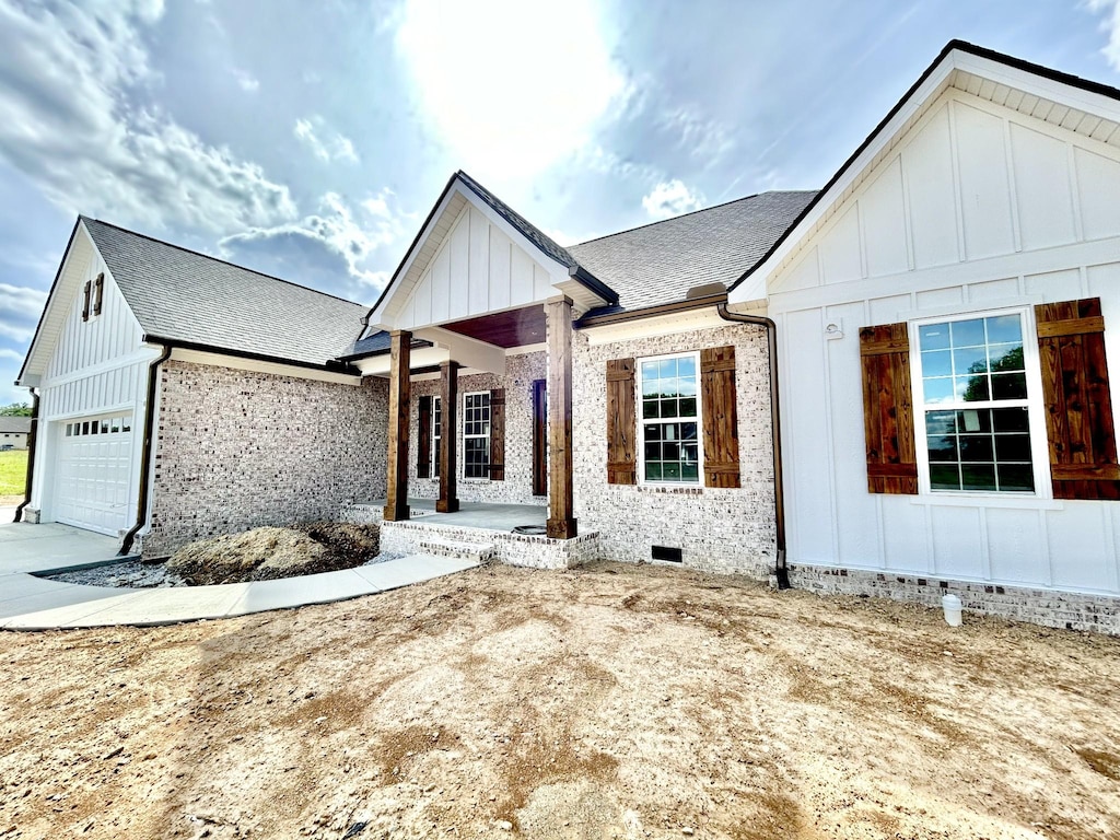 24 Hurst Dr, Leoma, TN 38468 - modern inspired farmhouse with board and batten siding, a garage, crawl space, brick siding, and a shingled roof