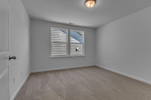 carpeted empty room with baseboards