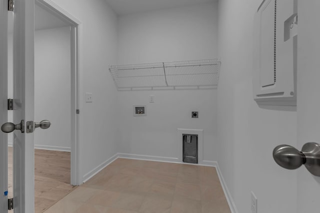 laundry room with cabinet space, washer hookup, hookup for an electric dryer, and baseboards