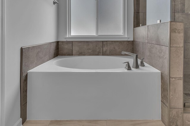 bathroom with a garden tub
