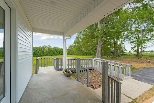 view of patio / terrace with a porch and view of scattered trees