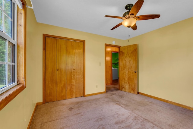 unfurnished bedroom with carpet flooring, baseboards, a closet, and ceiling fan