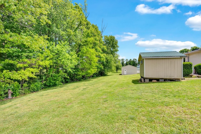 view of grassy yard with a shed and an outdoor structure