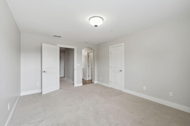 1000 Swanson Ln, Franklin, TN 37064 - spare room featuring arched walkways, carpet flooring, and baseboards