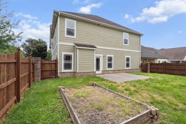 1000 Swanson Ln, Franklin, TN 37064 - rear view of property featuring a garden, a patio area, and brick siding