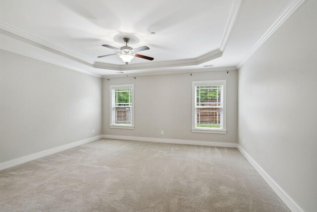 1000 Swanson Ln, Franklin, TN 37064 - spare room with a tray ceiling, crown molding, light colored carpet, ceiling fan, and baseboards