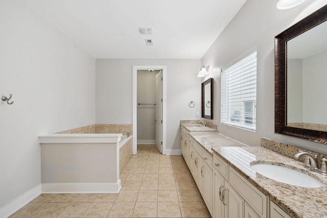 1000 Swanson Ln, Franklin, TN 37064 - bathroom with double vanity, baseboards, tile patterned flooring, and a bathtub