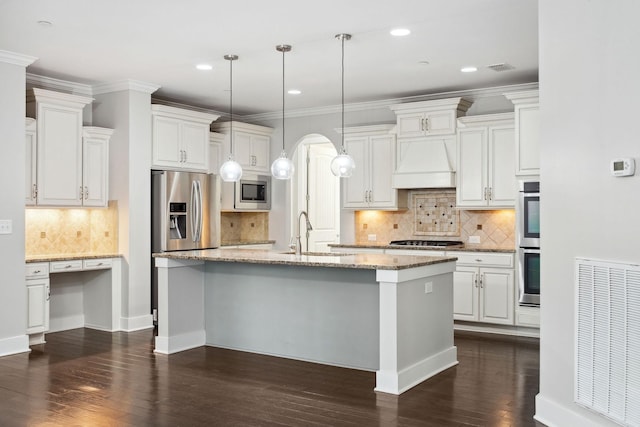 1000 Swanson Ln, Franklin, TN 37064 - kitchen with stainless steel appliances, a sink, premium range hood, a center island with sink, and decorative backsplash