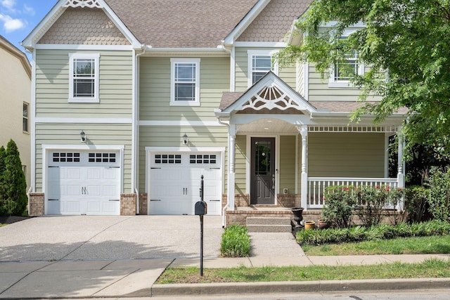 1000 Swanson Ln, Franklin, TN 37064 - view of front facade with a garage, driveway, covered porch, and a shingled roof