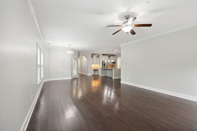 1000 Swanson Ln, Franklin, TN 37064 - unfurnished living room featuring a chandelier, ornamental molding, a ceiling fan, dark wood-style flooring, and baseboards