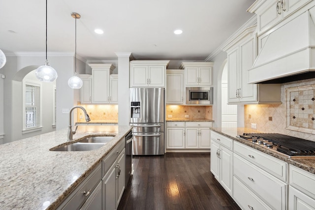 1000 Swanson Ln, Franklin, TN 37064 - kitchen featuring appliances with stainless steel finishes, premium range hood, arched walkways, a sink, and dark wood finished floors