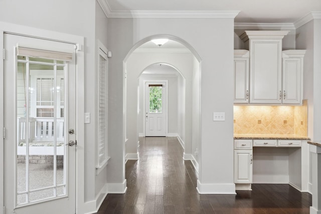 1000 Swanson Ln, Franklin, TN 37064 - foyer featuring dark wood-style flooring, arched walkways, crown molding, and baseboards