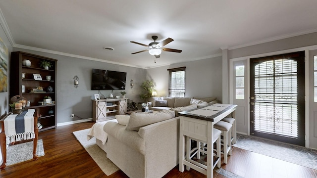 living room featuring ceiling fan, dark wood-type flooring, crown molding, and baseboards