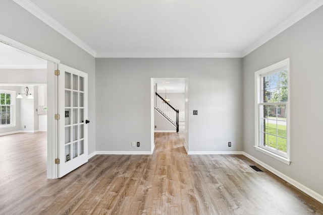410 Springhouse Ct, Franklin, TN 37067 - unfurnished room featuring a chandelier, light wood-style floors, ornamental molding, stairway, and baseboards