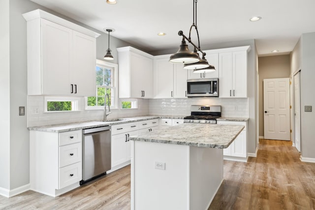 410 Springhouse Ct, Franklin, TN 37067 - kitchen with appliances with stainless steel finishes, a sink, recessed lighting, light wood finished floors, and white cabinetry