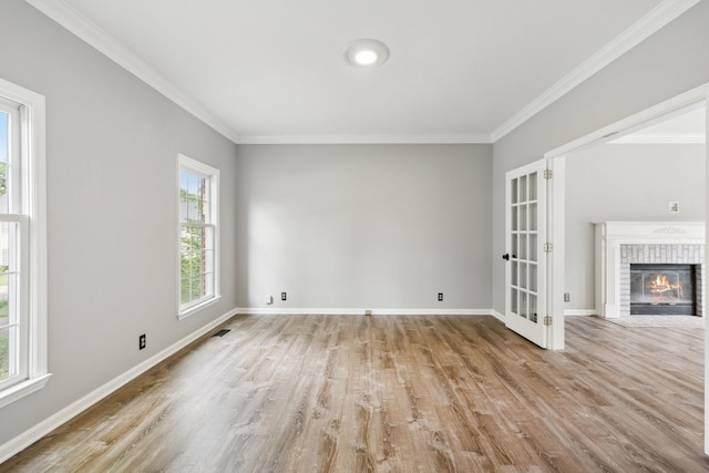 410 Springhouse Ct, Franklin, TN 37067 - unfurnished living room featuring wood finished floors, crown molding, baseboards, french doors, and a brick fireplace
