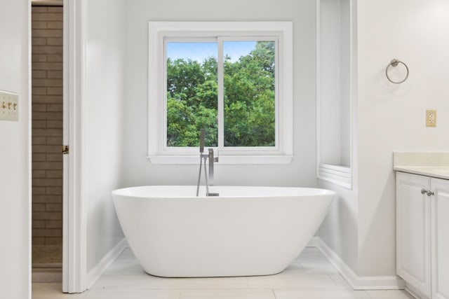 410 Springhouse Ct, Franklin, TN 37067 - bathroom with vanity, a freestanding tub, and baseboards