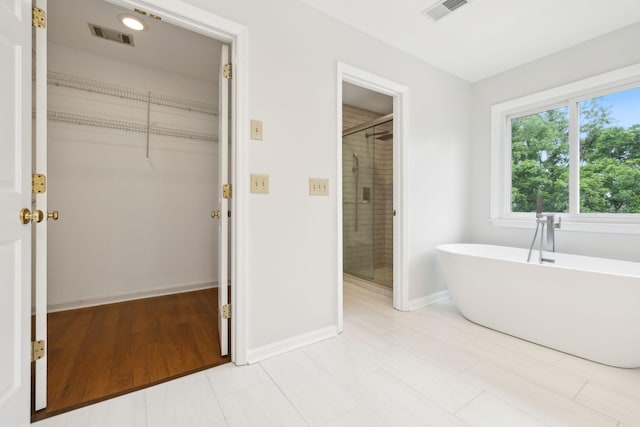 410 Springhouse Ct, Franklin, TN 37067 - full bath featuring a stall shower, a freestanding bath, a spacious closet, and baseboards