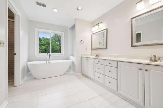 410 Springhouse Ct, Franklin, TN 37067 - full bathroom featuring a freestanding bath, double vanity, baseboards, and recessed lighting