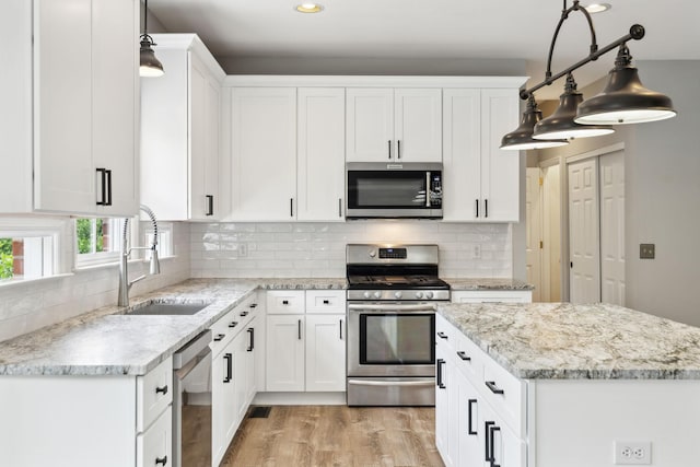 410 Springhouse Ct, Franklin, TN 37067 - kitchen with appliances with stainless steel finishes, a sink, recessed lighting, light wood-style floors, and white cabinets