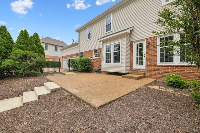 410 Springhouse Ct, Franklin, TN 37067 - rear view of property featuring brick siding, fence, entry steps, and a patio