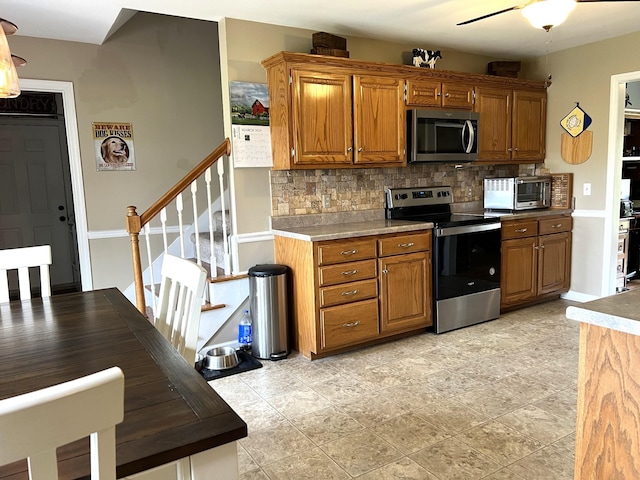 1224 Whiteside Hill Rd, Wartrace, TN 37183 - kitchen featuring stainless steel appliances, tasteful backsplash, brown cabinetry, and ceiling fan