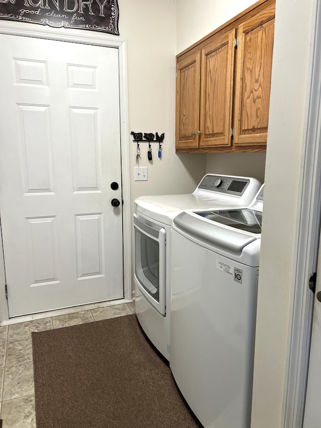 1224 Whiteside Hill Rd, Wartrace, TN 37183 - laundry room featuring washing machine and clothes dryer, cabinet space, and tile patterned floors