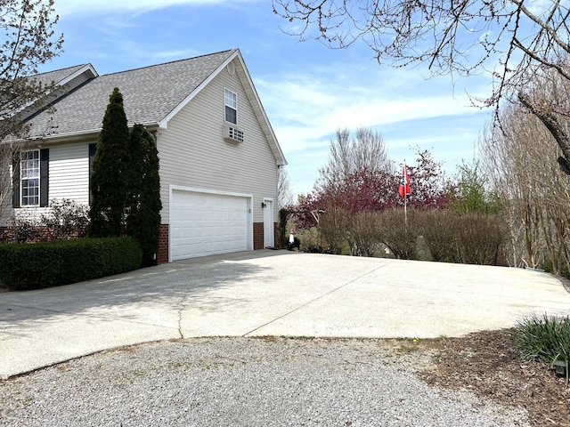 1224 Whiteside Hill Rd, Wartrace, TN 37183 - view of home's exterior featuring concrete driveway, a garage, a shingled roof, and brick siding