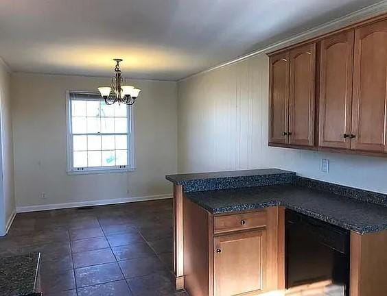 514 Wren Dr, Clarksville, TN 37040 - kitchen featuring dark countertops, a chandelier, a peninsula, dishwasher, and baseboards