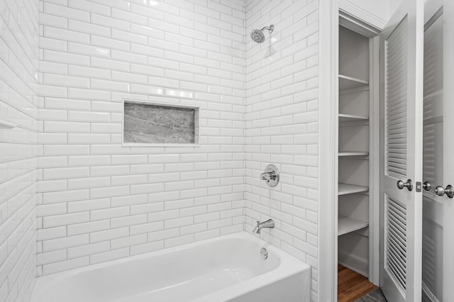 full bath with washtub / shower combination and wood finished floors