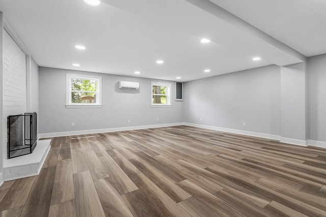 basement with wood finished floors, baseboards, recessed lighting, and healthy amount of natural light