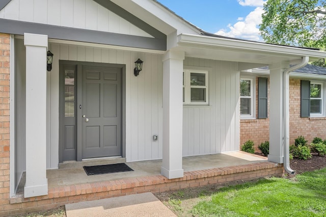 entrance to property featuring brick siding