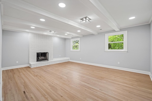 unfurnished living room with beam ceiling, baseboards, light wood-style flooring, a brick fireplace, and recessed lighting