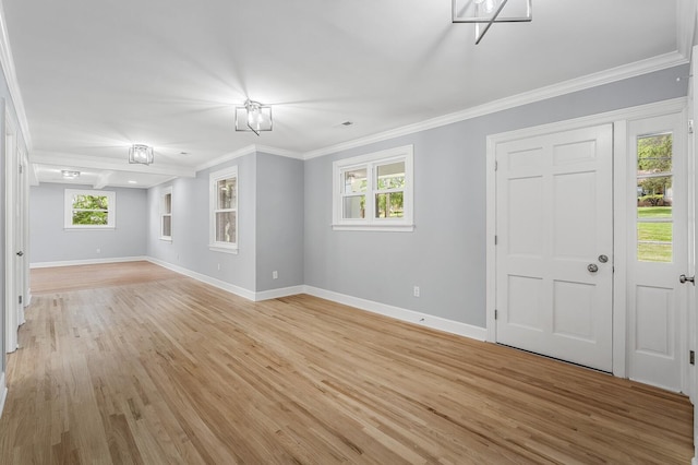 foyer with baseboards, light wood-style flooring, and ornamental molding
