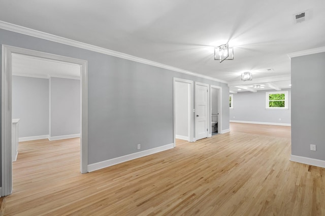 unfurnished room with crown molding, light wood finished floors, and baseboards