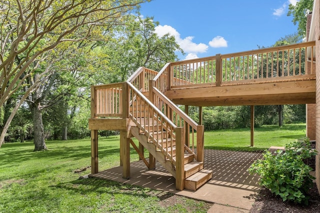 view of playground featuring stairway, a wooden deck, and a lawn