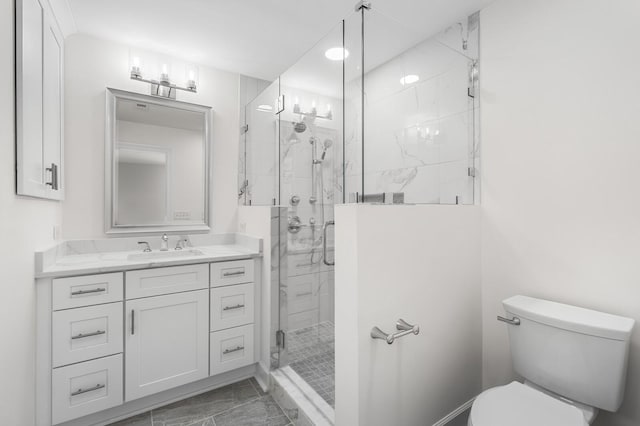 bathroom featuring marble finish floors, toilet, a stall shower, and vanity