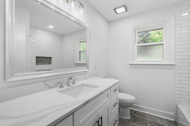bathroom featuring toilet, a tub, vanity, baseboards, and a shower