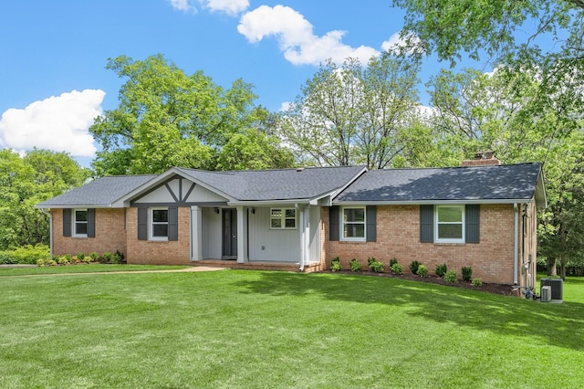 ranch-style home featuring brick siding, a front lawn, and covered porch