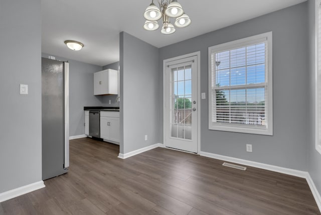 1493 Mcclardy Rd, Clarksville, TN 37042 - unfurnished dining area with baseboards, a chandelier, and dark wood-type flooring