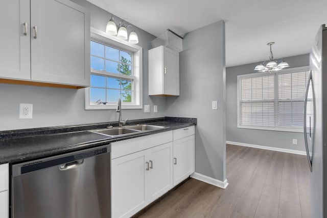 1493 Mcclardy Rd, Clarksville, TN 37042 - kitchen featuring appliances with stainless steel finishes, a sink, dark countertops, a chandelier, and white cabinets