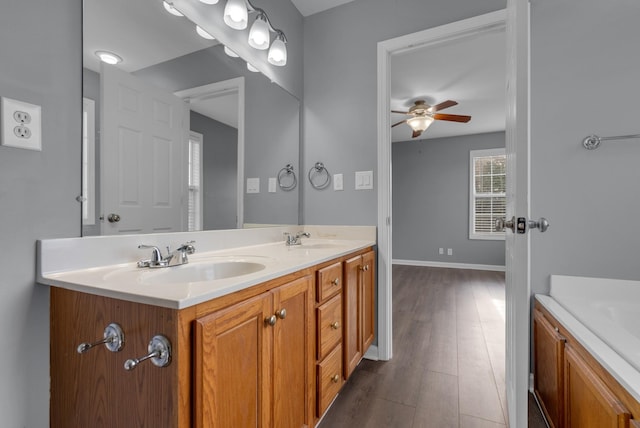 1493 Mcclardy Rd, Clarksville, TN 37042 - bathroom with a ceiling fan, double vanity, wood finished floors, and baseboards