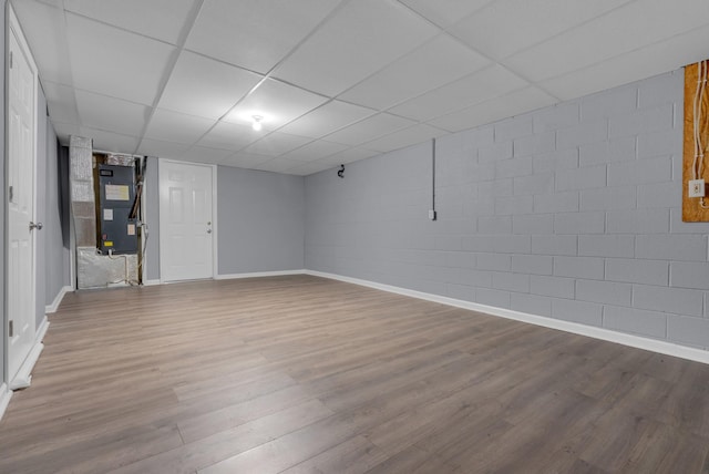 1493 Mcclardy Rd, Clarksville, TN 37042 - finished below grade area featuring wood finished floors, baseboards, a paneled ceiling, concrete block wall, and heating unit