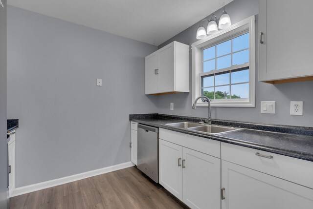1493 Mcclardy Rd, Clarksville, TN 37042 - kitchen with a sink, stainless steel dishwasher, dark countertops, dark wood-style floors, and white cabinets