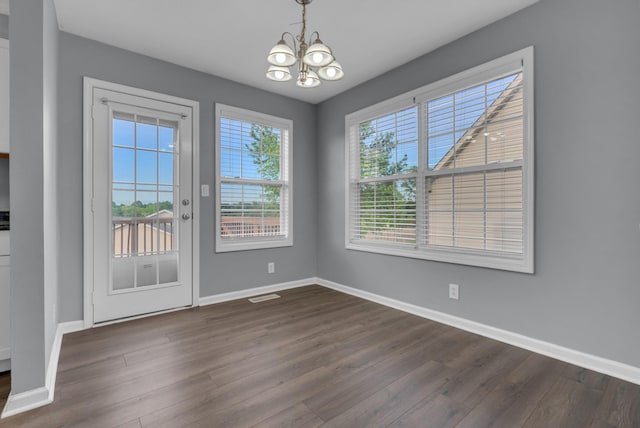 1493 Mcclardy Rd, Clarksville, TN 37042 - unfurnished dining area featuring a chandelier, dark wood-style flooring, and baseboards