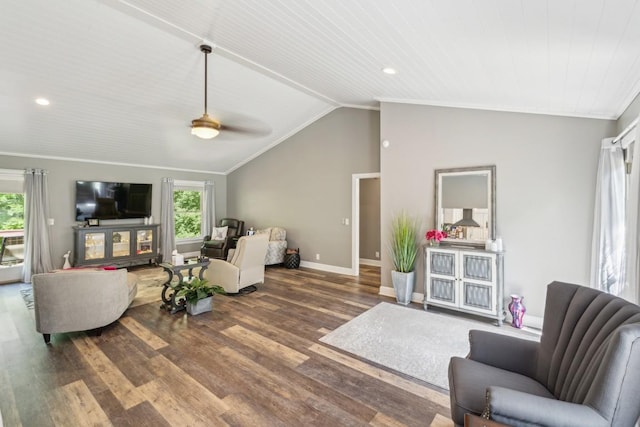 living room featuring plenty of natural light, vaulted ceiling, ornamental molding, baseboards, and wood finished floors