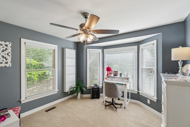 office with baseboards, plenty of natural light, and light carpet